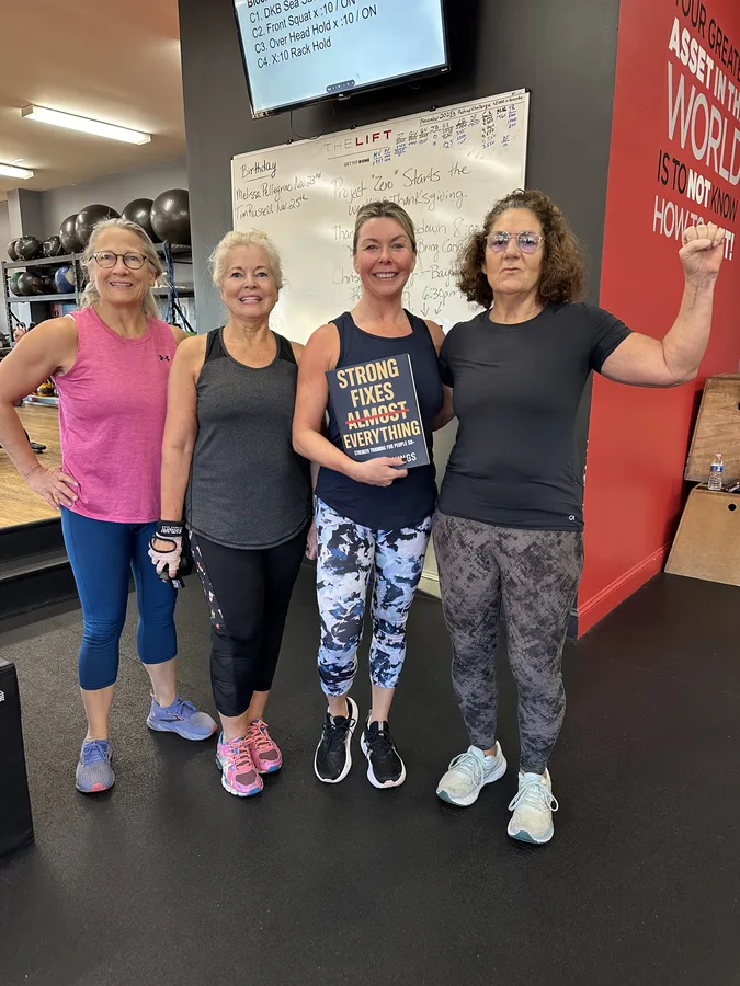 Members of The Lift Gym holding Strong Fixes Almost Everything